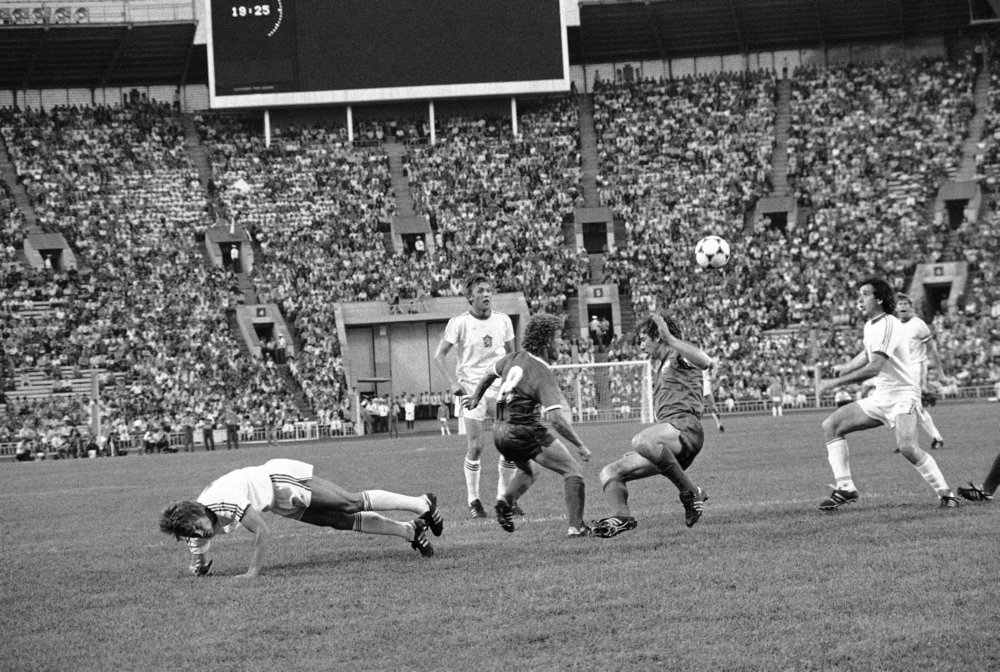 Unidentified Czechoslovakian player, left, kicks ball between two unidentified E.jpg