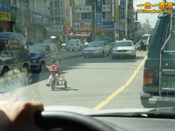 Child_Cycling_On_Road.jpg