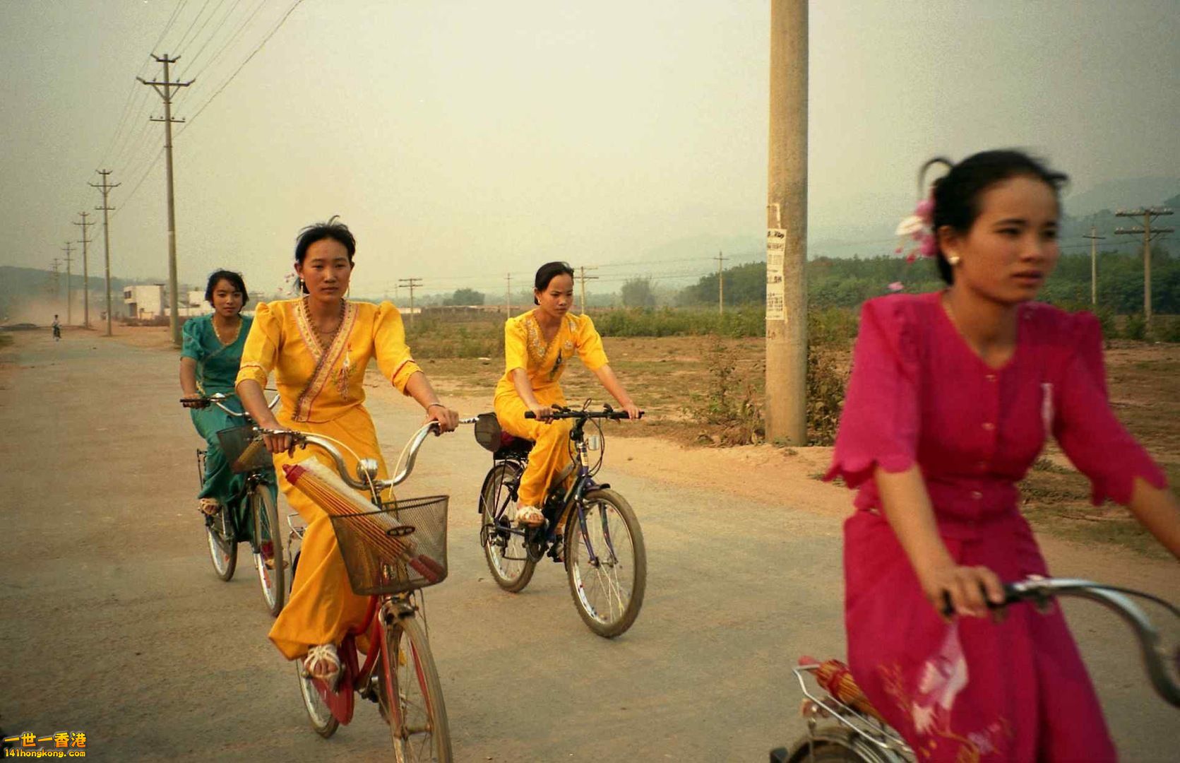 Dai_girls_on_bicycles_outside_of_Mengla_Xishuangbanna_Region_Yunnan_China.jpg