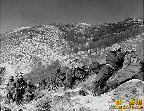 Marines under the cover of a large boulder engaging the Chinese..jpg