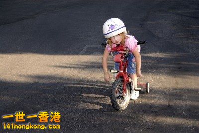 3420045-little-girl-riding-a-bike-wearing-a-helmet.jpg