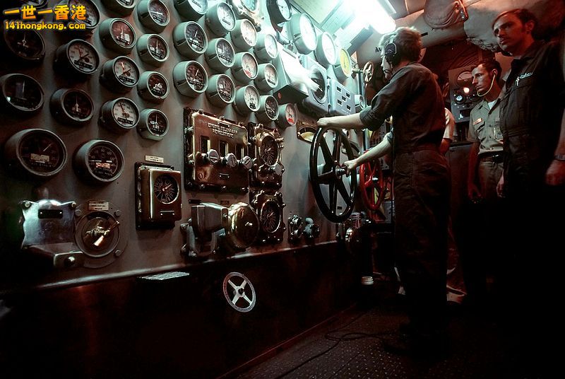 A crewman operates the ship\'s throttle in the main engine room aboard Ne.jpg