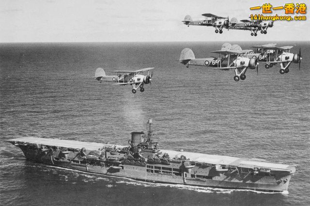 The aircraft carrier Ark Royal with a flight of Swordfish overhead.jpg