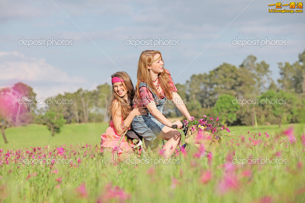 depositphotos_6469794-Happy-girls-riding-bike-or-bicycle-in-summer-meadow.jpg