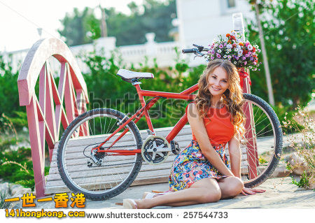 stock-photo-woman-wearing-a-spring-skirt-like-vintage-pin-up-holding-bicycle-wit.jpg