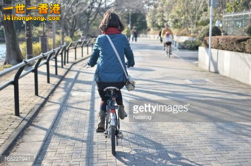 168227941-girl-is-riding-a-bike-in-the-park-road-gettyimages.jpg