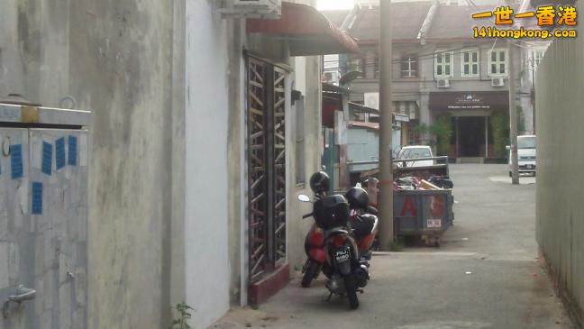 Brothel opposite Soo Chow, Penang. Its the one with the brown grill. Bike in front of it.