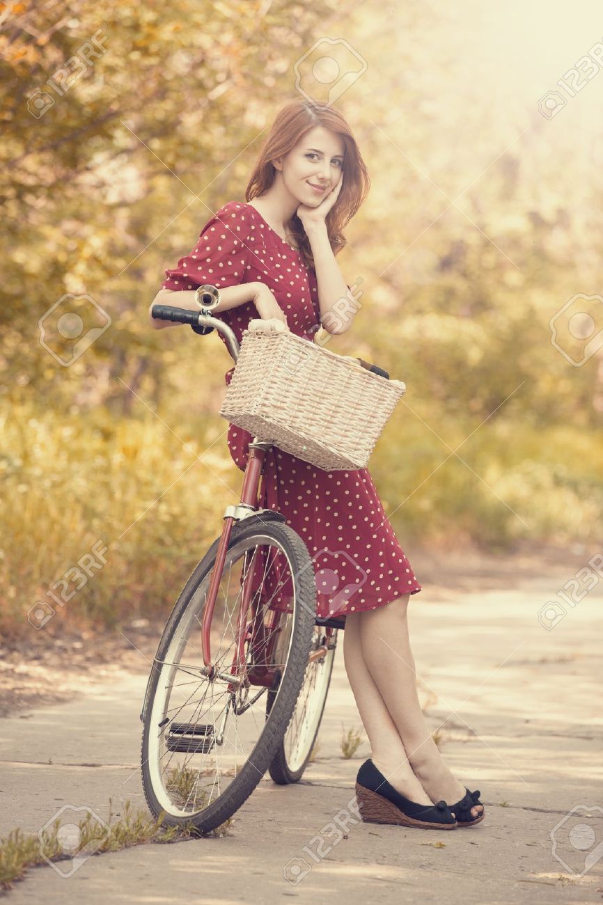 19583761-Beautiful-girl-with-bike-at-countryside-Vintage--Stock-Photo-woman-beau.jpg