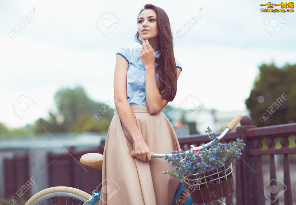 31003258-Young-beautiful-elegantly-dressed-woman-with-bicycle-Beauty-fashion-and.jpg