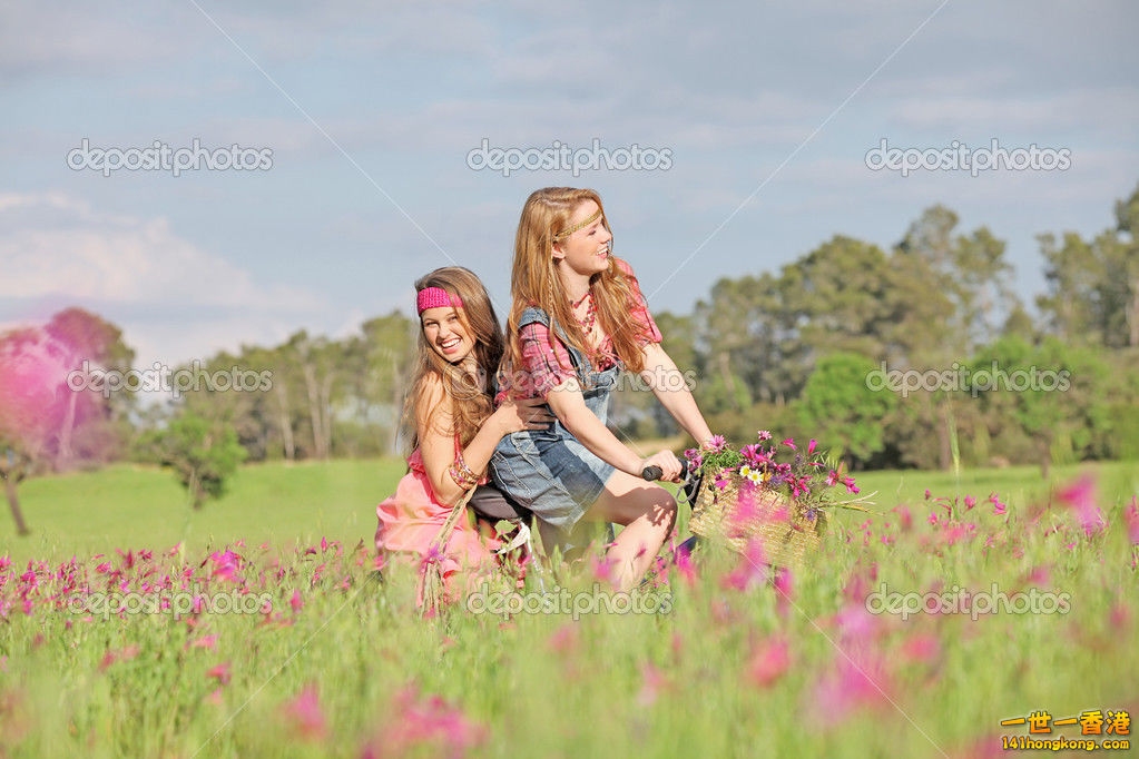 depositphotos_6469794-Happy-girls-riding-bike-or-bicycle-in-summer-meadow.jpg