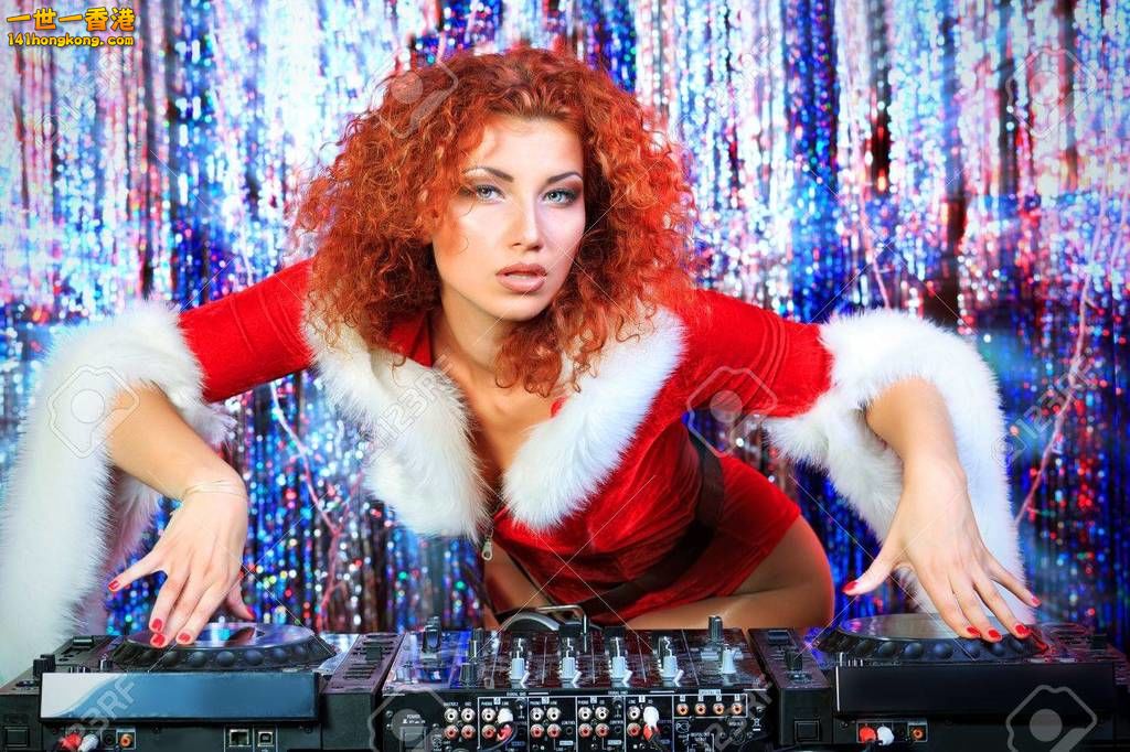 16289651-attractive-dj-girl-mixing-up-some-christmas-cheer-disco-lights-in-the-b.jpg
